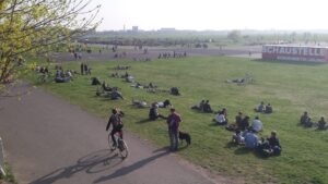 Wide concrete runways with skaters, cyclists and community gardens at Tempelhofer Feld