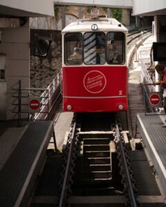 Modern red and white funicular car approaching Fourvière upper station